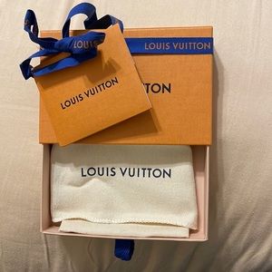 Authentic Louis Vuitton box and dust bag for small accessory.